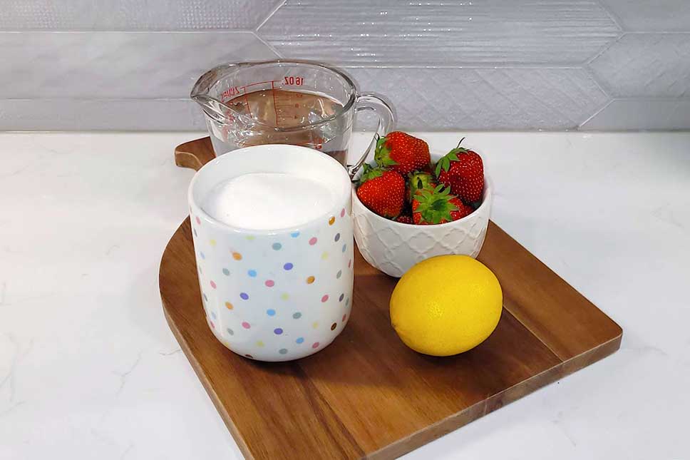 Strawberry simple syrup ingredients on a counter.