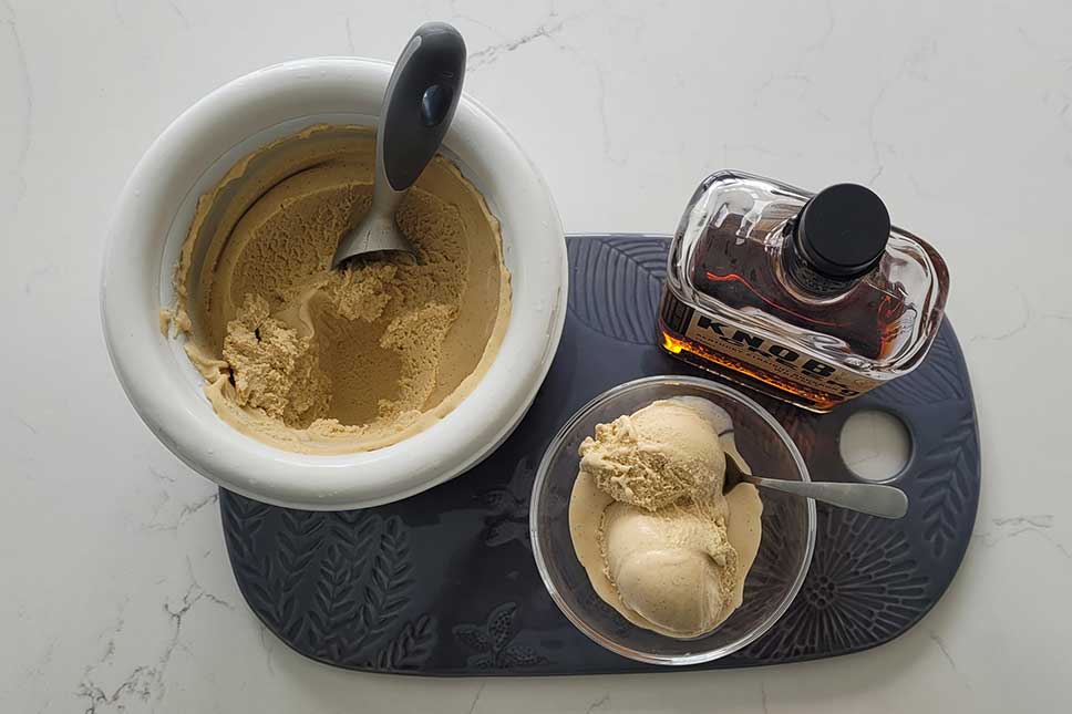 Bourbon Vanilla Ice Cream on a tray with a bottle of bourbon.