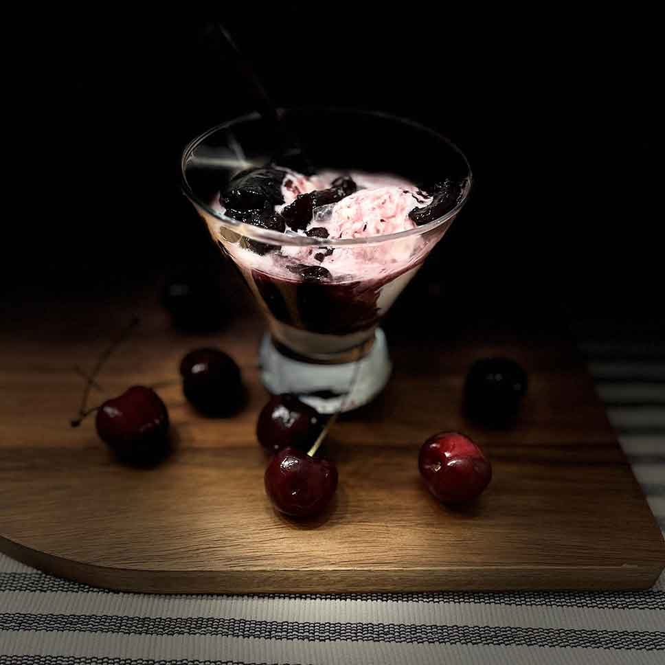 Smoked bourbon cherry sauce poured over ice cream.