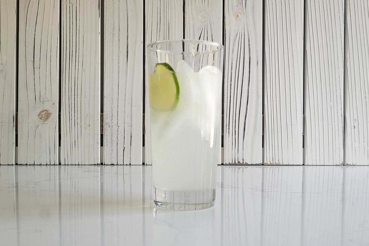 A paloma with a slice of lime on a counter.
