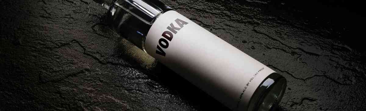 Vodka bottle lying on a black table.