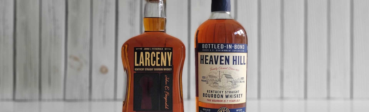 Bottles of Heaven Hill Bottled-in-Bond and Larceny Barrel Proof Whiskey on a counter.