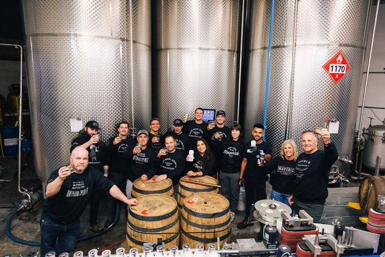 Maverick staff in the distillery with stills in the background.