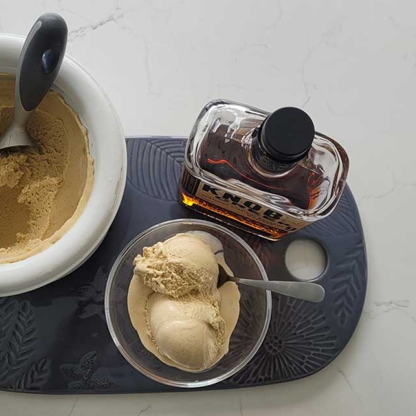 Bourbon Vanilla Ice Cream on a tray with a bottle of bourbon.