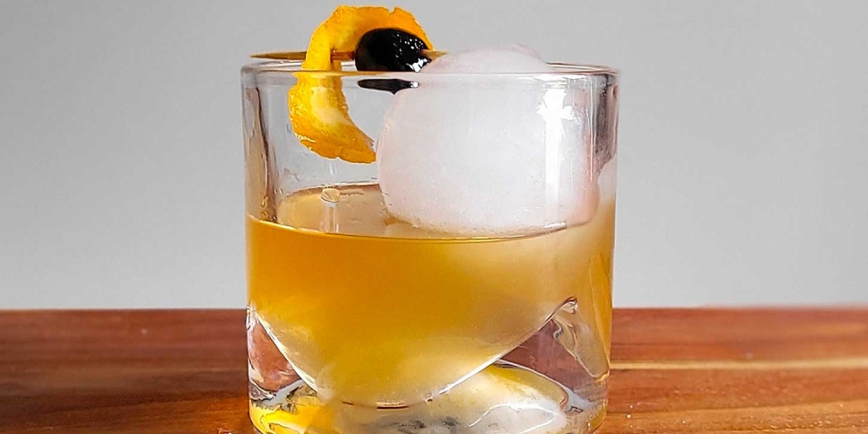 Brown Butter Old Fashioned with a maraschino cherry and a twist.