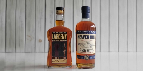 Bottles of Heaven Hill Bottled-in-Bond and Larceny Barrel Proof Whiskey on a counter.