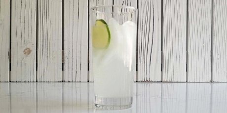 A paloma with a slice of lime on a counter.