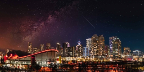 Calgary skyline at night with the Saddledome and the Milky Way.