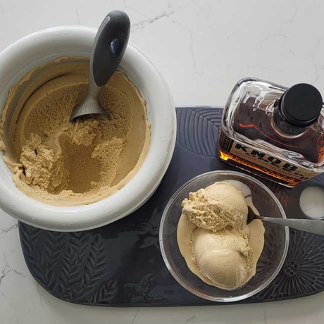 Bourbon Vanilla Ice Cream on a tray with a bottle of bourbon.