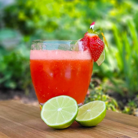 Strawberry Lime Fizz cocktail with fresh limes.