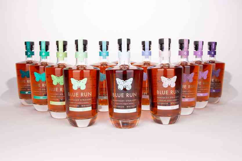 12 bottles of bourbon on table for Blue Run Spirits 2022 12 Days of Bourbon.