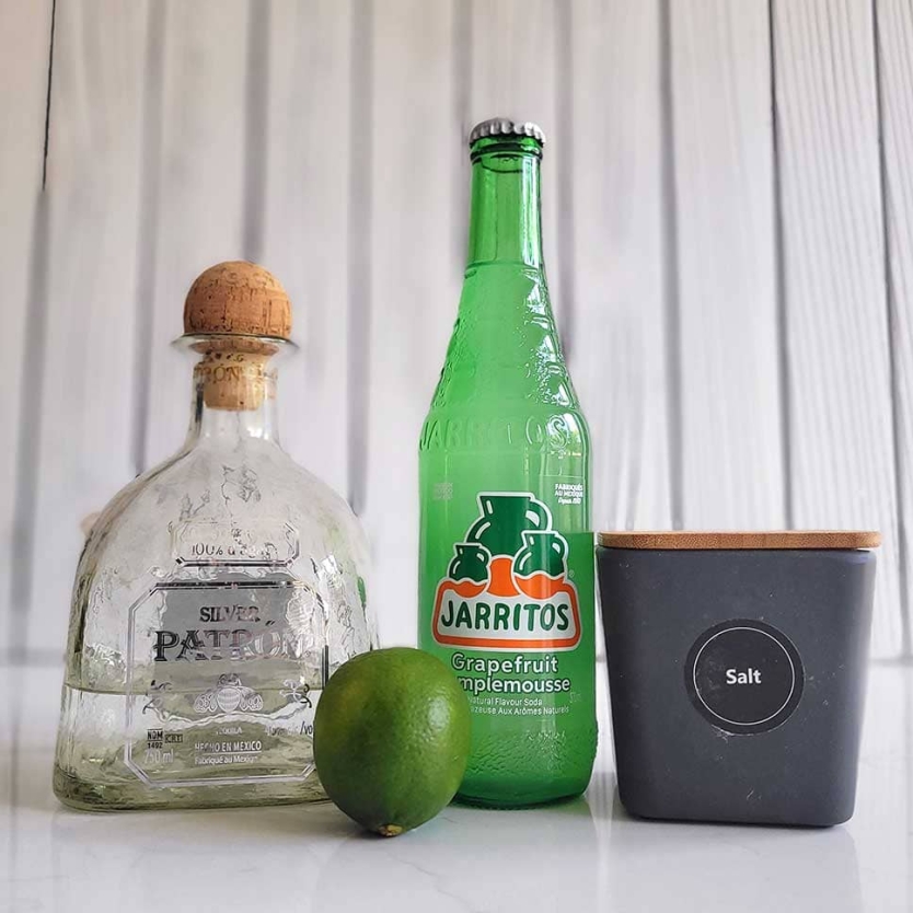 Paloma ingredients including tequila, grapefruit soda, lime and salt.
