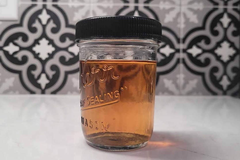 Jar of bacon fat washed bourbon, ready to make cocktails.